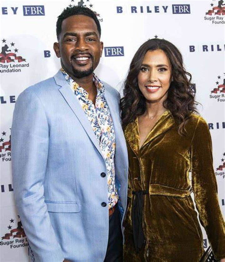 Bill Bellamy and wife posing at the premiere of Like Mike at the