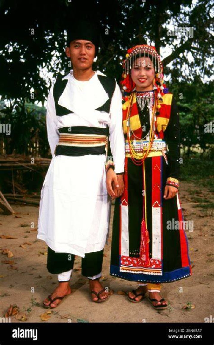 Burma/Myanmar A Kachin couple in ethnic dress. The Shan text