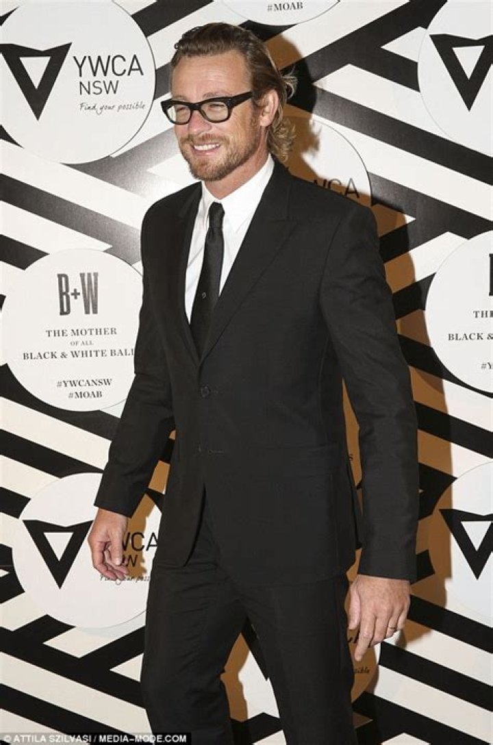 Simon Baker plants big smacker on wife's cheek at Mother Of All Balls